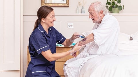 Old man with skin tears, Nurse applying dressing